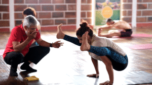Woman practicing beginner yoga for health and balance at yoga institute Mysore