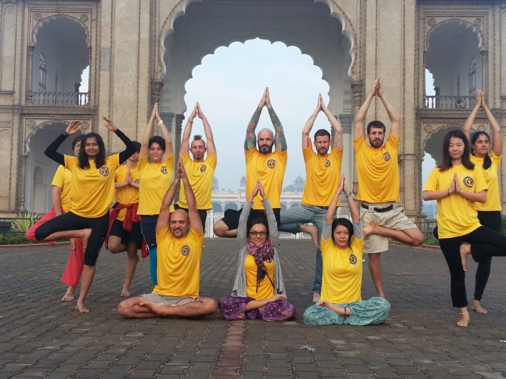 Yoga students posing near Mysore palace in asthanga yoga capital of world