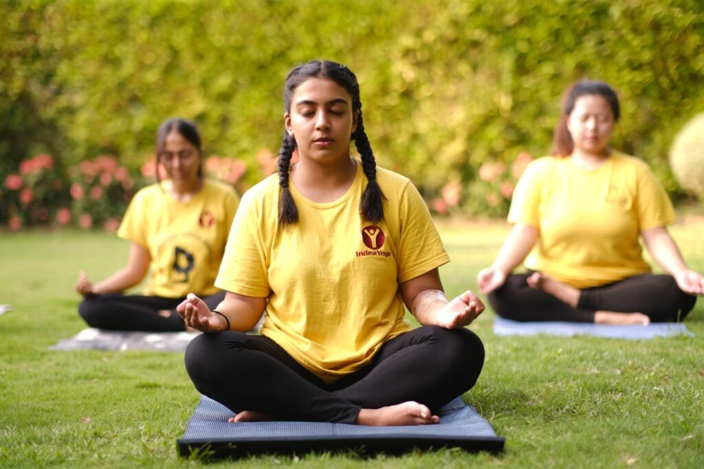 Yoga of PCOS (Polycystic Ovary Syndrome), 3 women practicing in an open garden.