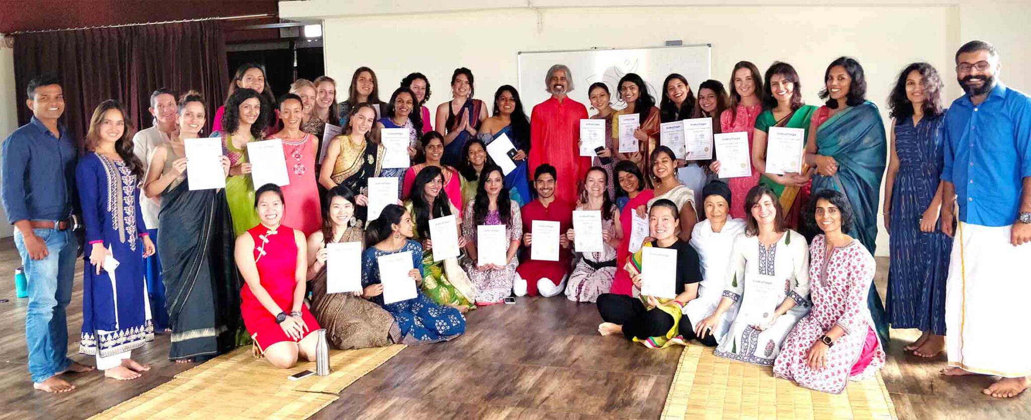 on completion of ashtanga teacher training course, students receiving their certificates, this a graduation ceremony.