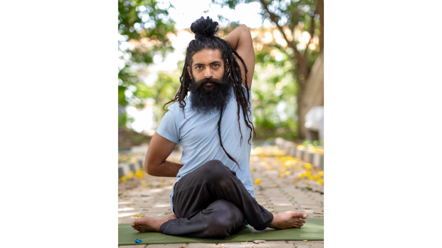 a man performing cow face pose out in nature