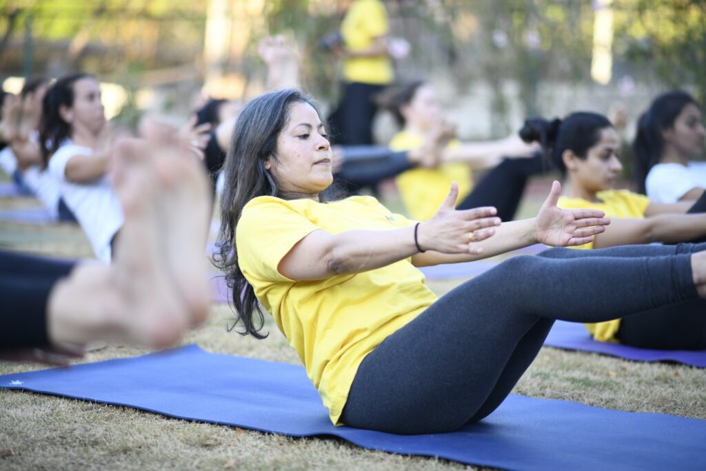 a group of students holding navasana comfortably